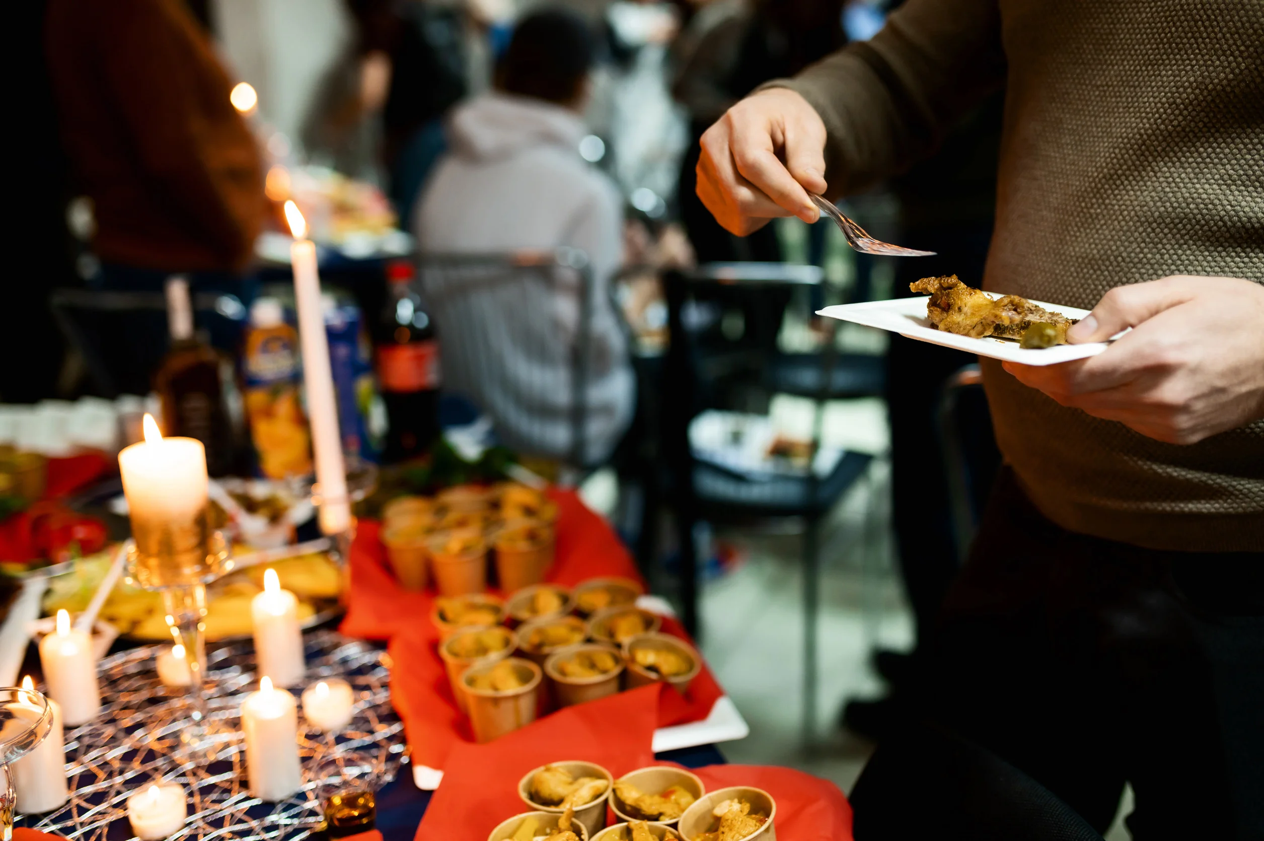 Person serving food at a festive dinner table.