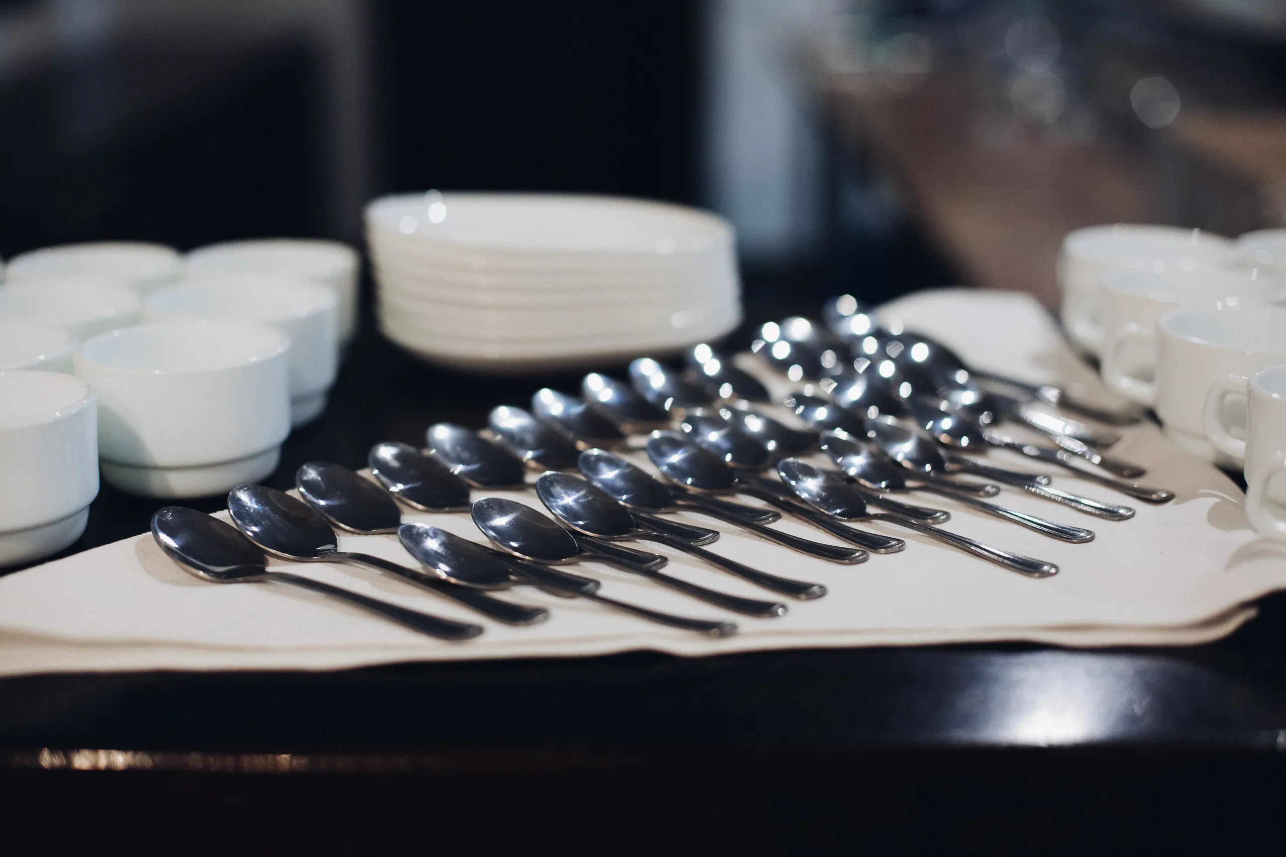 Spoons and cups neatly arranged on a table