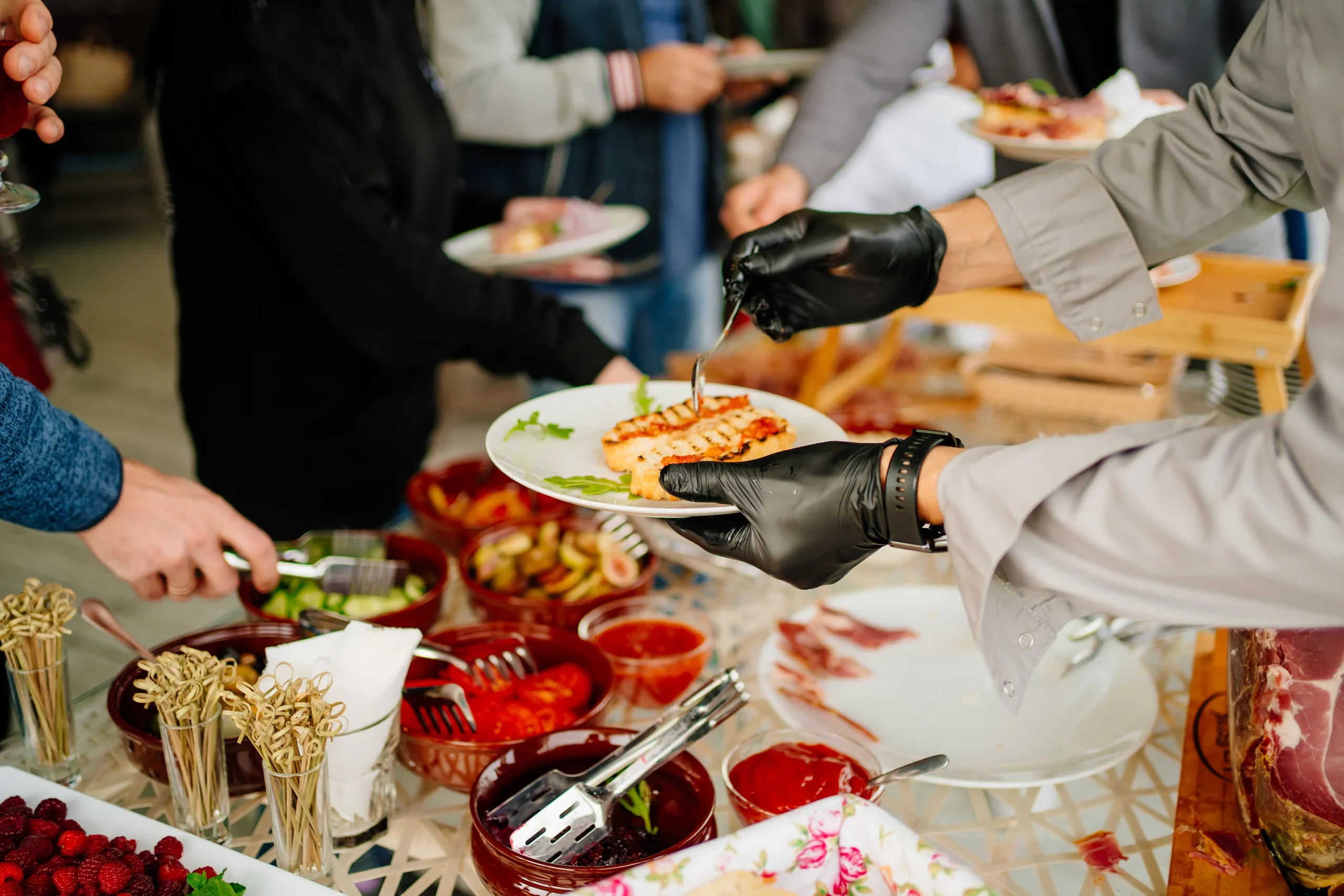 Buffet table with hands serving food